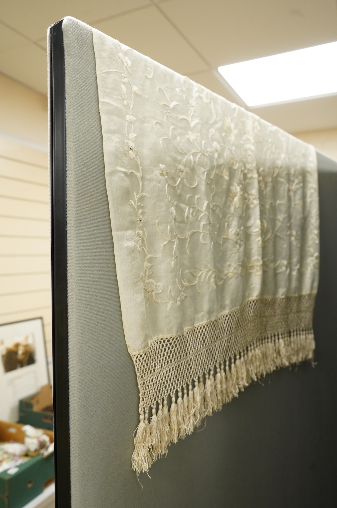 An early 20th century Chinese cream on cream silk embroidered, fringed stole, 65cm wide. Condition - some light staining.